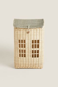 a white wicker basket with two doors on the front and one door in the back