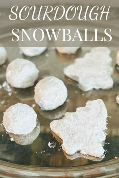 snowball cookies sitting on top of a glass plate with the words sourdough snowballs