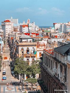 an aerial view of a city with lots of tall buildings and cars parked on the street