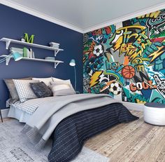 a bedroom decorated in blue and white with graffiti on the wall, bedding and rugs