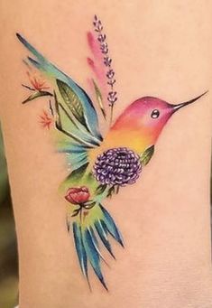 a colorful humming bird with flowers on its back side ribcage, tattoo design