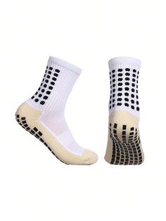 a pair of white socks with black dots on them