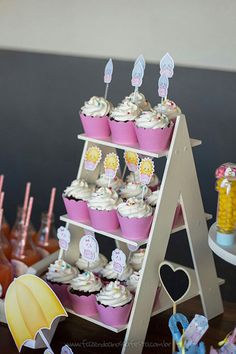 a table topped with lots of cupcakes and candy