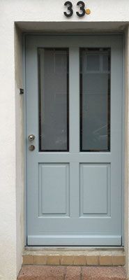 a blue front door with two glass panels and numbers on the side of each door