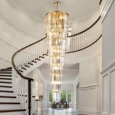 a large chandelier hanging from the side of a spiral staircase