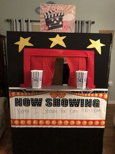 a small stage set up for a show with popcorn cups on the front and sides