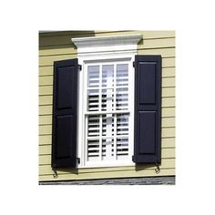 an open window with shutters on the side of a house