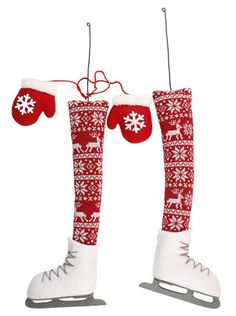 pair of red and white ski boots with snowflakes hanging from the strings on a white background