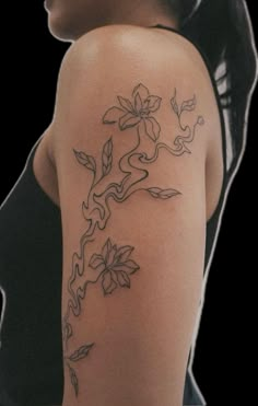 a woman with a flower tattoo on her arm