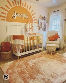 a baby's room with an orange and white rug, sun - themed wall decal, and a gold crib