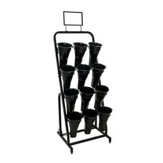 a rack with many black pots on it