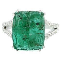 This ring has been meticulously crafted from 18-karat gold. It is hand set in 8.16 carats carved emerald & .24 carats of diamonds. The ring is a size 7 and may be resized to larger or smaller upon request. FOLLOW MEGHNA JEWELS storefront to view the latest collection & exclusive pieces. Meghna Jewels is proudly rated as a Top Seller on 1stDibs with 5 star customer reviews. All items manufactured by us are handmade and can be customized or redesigned. Composition Size-US-7 Total Weight-5.525 Gold Weight(Gms)-3.844 Diamond Wt(Cts)-0.24 Emerald Wt(Cts)-8.16 Luxury Emerald Gemstones With Prong Setting, Luxury Emerald Cut Gemstone With 17 Jewels, Luxury Green Diamond Ring In Platinum, Diamond Intaglio Rings, Fine Jewelry, Fine Jewelry Diamond With Intaglio Detail, Diamond Intaglio Fine Jewelry Rings, Fine Jewelry Diamond Intaglio, Oval Emerald Ring With Single Cut Diamonds, Fine Diamond Intaglio Jewelry