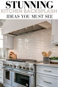 a kitchen with white cabinets and stainless steel stove top oven, in the middle of it is