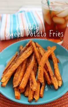 sweet potato fries on a blue plate next to a cup of tea and a napkin