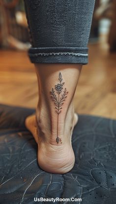 a woman's foot with a small flower tattoo on the side of her leg