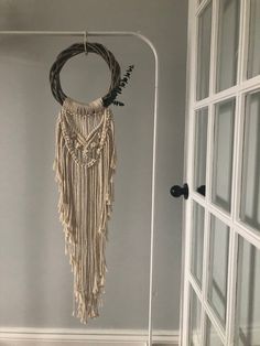 the door is open and there is a macrame hanging from it