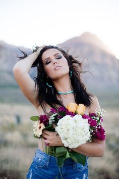 a beautiful woman holding a bouquet of flowers