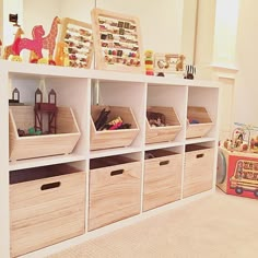 toy storage bins with wooden crates and toys on top in a playroom area