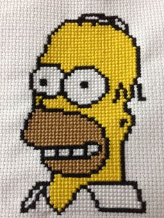 the simpsons cross stitch pattern on a white t - shirt with black and yellow trim