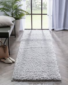 a large white rug in front of a window