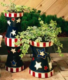 three potted plants with stars and stripes painted on them