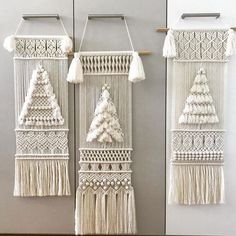 macrame wall hangings with tassels and trees on them in white