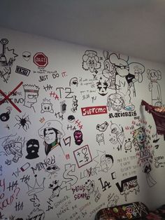 a room with graffiti written on the wall and various other things drawn on the wall