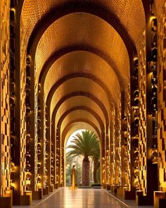 the inside of a large building with many columns and lights on each side of it