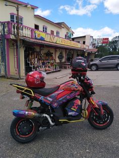 a colorful motorcycle parked in front of a store