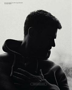 a man standing in front of a window next to a rain covered window sill