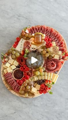 a platter with cheese, meats and vegetables on it is shown from above