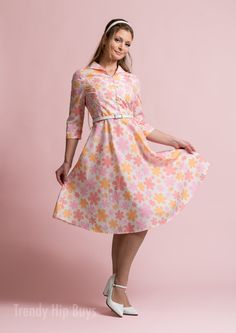 *  Embrace timeless elegance with our Vintage Style Dress, evoking the charm of 50s and 60s Dress Style. * This Vintage Inspired Dress features a Pastel Orange, Pink Floral pattern, perfect for adding a touch of vintage flair to your wardrobe. * Crafted from a cotton-like polyester blend, this A-line Dress offers both comfort and style, ideal for all-day wear. * With a wing collar neckline and 3/4 sleeves, this Vintage Shirt Dress Style exudes sophistication, while the knee-length A-line skirt adds a classic silhouette to your look. Designed in California by Trendy Hip Buys. Handmade to order from overseas Made from 100% Polyester Machine washable Weight: 110 gsm 1940s Fashion Dresses, 1950s Fashion Dresses, Dresses 1950s, Vintage Shirt Dress, Wing Collar, Pastel Orange, Pin Up Dresses, 1980s Fashion, 60s Dress