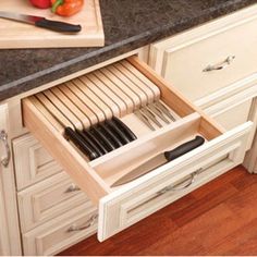 an open drawer in a kitchen filled with utensils