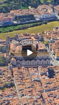 an aerial view of a city with lots of buildings and water in the middle of it