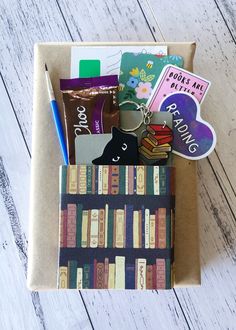 an open cardboard box containing books and magnets