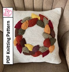 a knitted wreath pillow sitting on top of a chair