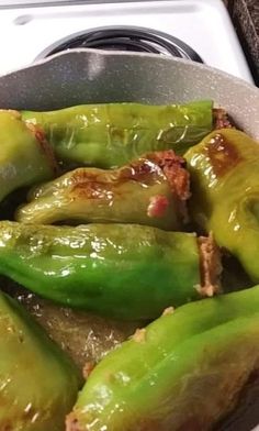 some green peppers are in a pan on the stove