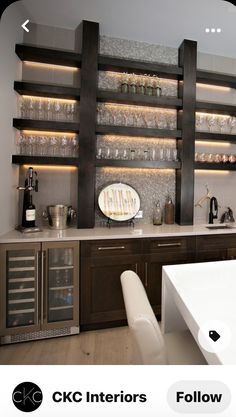 an image of a kitchen setting with wine glasses on the counter and shelves above it