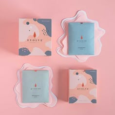 three square coasters sitting on top of a pink wall next to each other with the words evolve