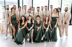 a group of men and women in formal wear posing for a photo with each other