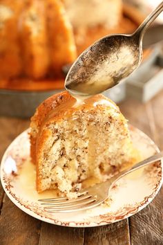 a piece of cake on a plate with a fork sticking out of it and being eaten