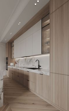 a large kitchen with marble counter tops and wooden cabinets, along with hardwood flooring