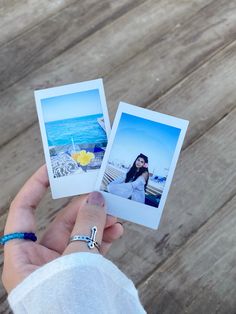 two polaroid photos held in one hand and the other with a ring on it