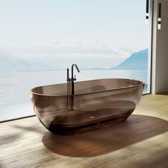 a large bath tub sitting on top of a wooden floor