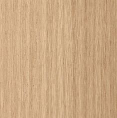 a close up view of the grained surface of a wood paneling material that is light brown