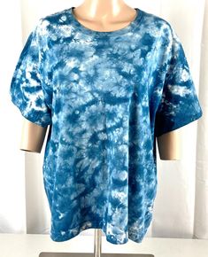 a woman's blue and white tie dye shirt on a mannequin head