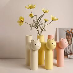 three vases with yellow flowers in them on a table next to a photo and an image