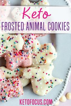 keto frosted animal cookies on a plate with sprinkles