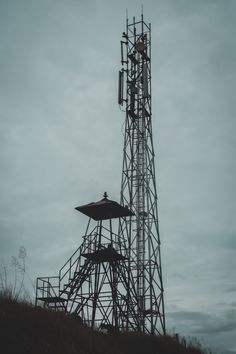 a tall tower sitting on top of a lush green hillside