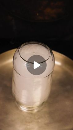 an empty glass sitting on top of a metal plate